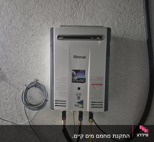 מחמם מים מותקן על קיר עם צינורות מחוברים